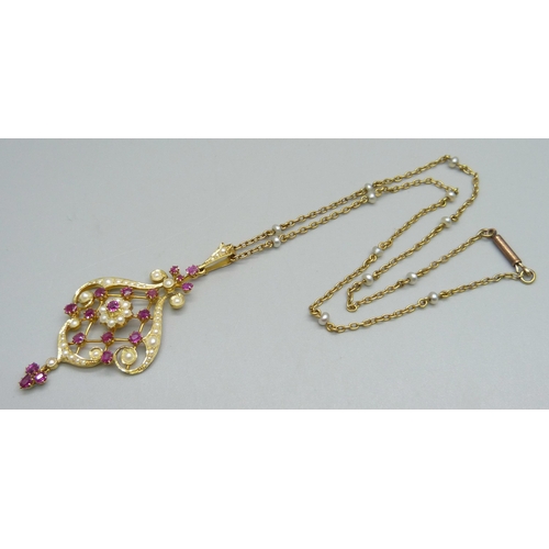 1010 - A 15ct gold Art Nouveau drop pendant set with rubies and seed pearls, 5.8cm including bale and drop,... 