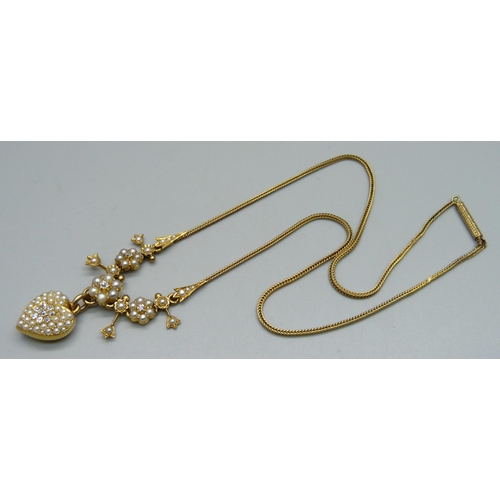 1011 - A yellow metal necklet set with a diamond cluster and seed pearls on a foxtail link chain, chain rep... 