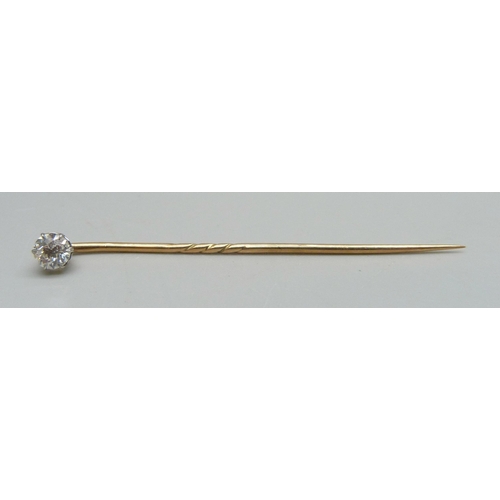 1014 - A yellow metal and diamond set stick pin, 0.9g, 5.3cm