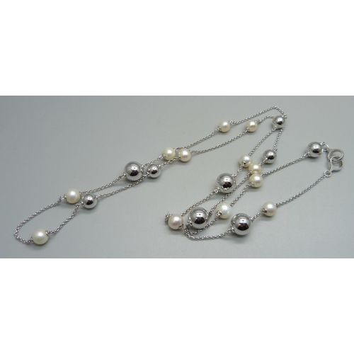 1029 - A Georg Jensen silver and cultured pearl guard chain, 39g, approximately 97cm