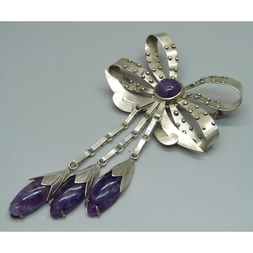 1054 - A silver .980 Mexican brooch set with amethyst stones, 46g, lacking pin, approximately 13.5cm long