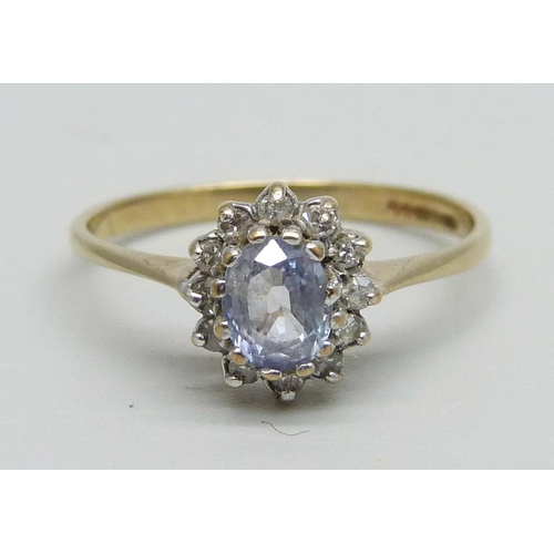 1060 - A 9ct gold cluster ring set with a light purple stone and small diamonds, 1.4g, L