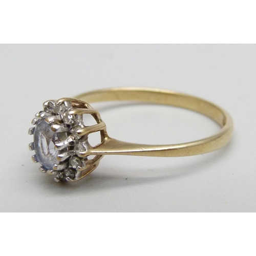 1060 - A 9ct gold cluster ring set with a light purple stone and small diamonds, 1.4g, L