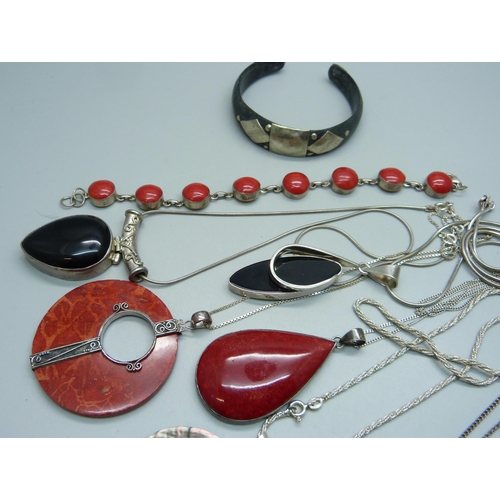 1075 - A collection of silver jewellery, many pieces set with coral including pendants, a bracelet, earring... 