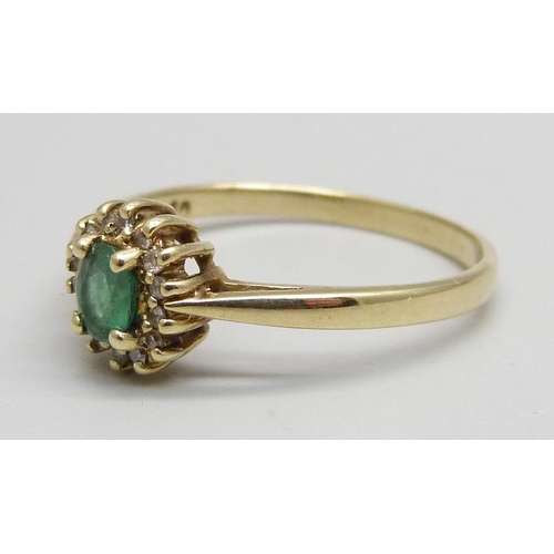 1080 - A 9ct gold, emerald and diamond cluster ring, 2.2g, U