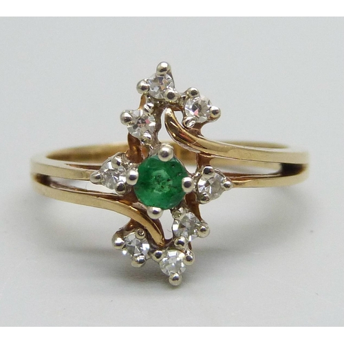 1083 - A yellow metal ring marked 10-14k, set with an emerald and eight diamonds, signed Bermark, 2.4g, M