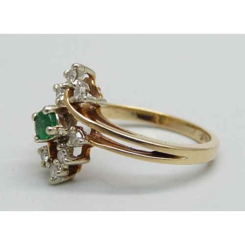 1083 - A yellow metal ring marked 10-14k, set with an emerald and eight diamonds, signed Bermark, 2.4g, M