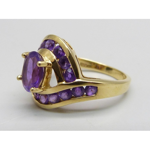 1089 - An 18ct gold, and amethyst set crossover ring, 5.1g, M/N