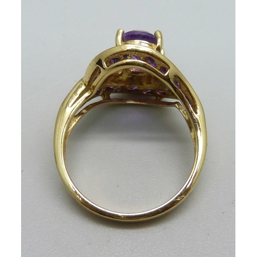 1089 - An 18ct gold, and amethyst set crossover ring, 5.1g, M/N