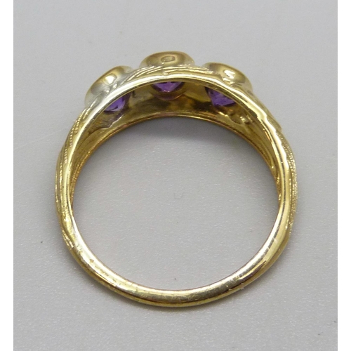 1096 - A silver gilt, three stone amethyst ring, T