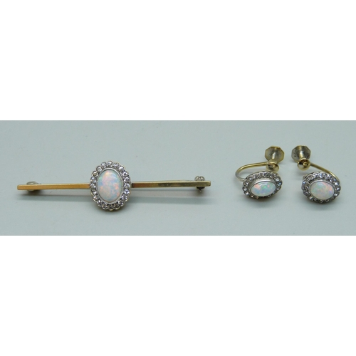 1105 - A gilt metal brooch set with a simulated opal and white stone cluster, and a pair of matching screw ... 