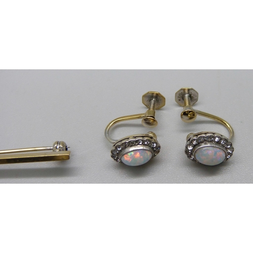 1105 - A gilt metal brooch set with a simulated opal and white stone cluster, and a pair of matching screw ... 