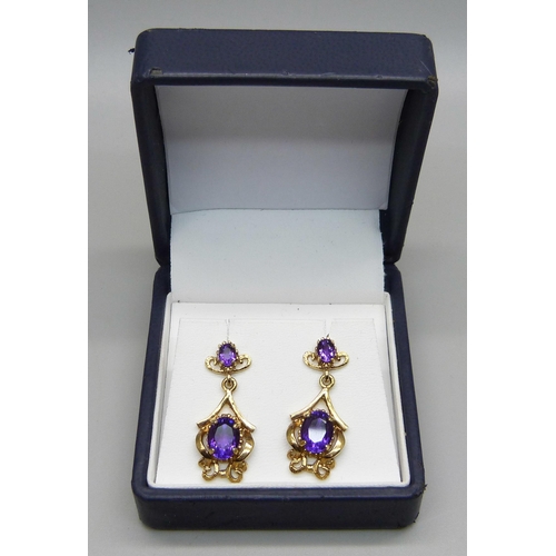 1108 - A pair of 9ct gold and amethyst set drop earrings, hallmarked on the posts, 5.9g, 3cm drop