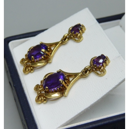 1108 - A pair of 9ct gold and amethyst set drop earrings, hallmarked on the posts, 5.9g, 3cm drop