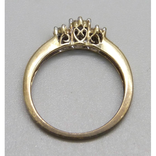 1114 - A 9ct gold ring set with three diamond clusters and diamond shoulders, 2.2g, O