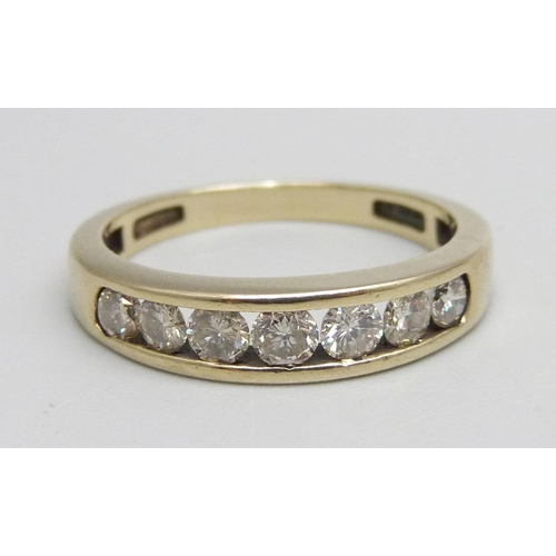 1121 - A 9ct gold, seven stone diamond half eternity ring, shank stamped 0.75ct, 3g, R