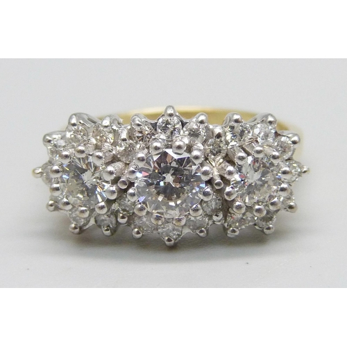 1124 - An 18ct gold, 27 stone diamond ring, London 1987, three central diamonds measure 1ct in total, enclo... 