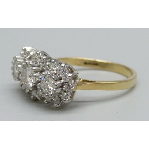 1124 - An 18ct gold, 27 stone diamond ring, London 1987, three central diamonds measure 1ct in total, enclo... 