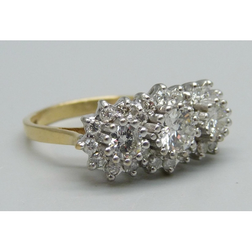 1124 - An 18ct gold, 27 stone diamond ring, London 1987, three central diamonds measure 1ct in total, enclo... 