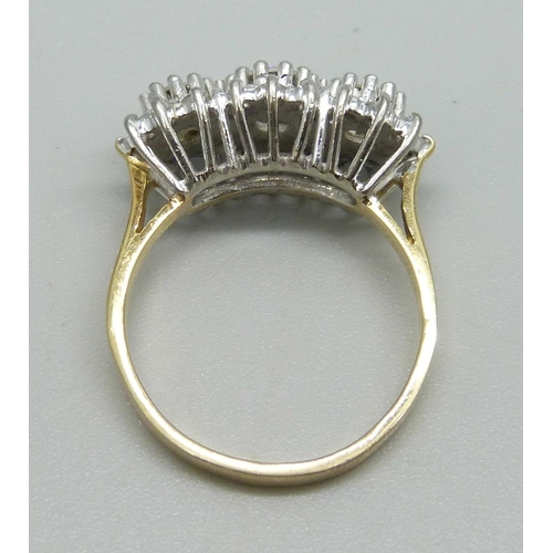 1124 - An 18ct gold, 27 stone diamond ring, London 1987, three central diamonds measure 1ct in total, enclo... 