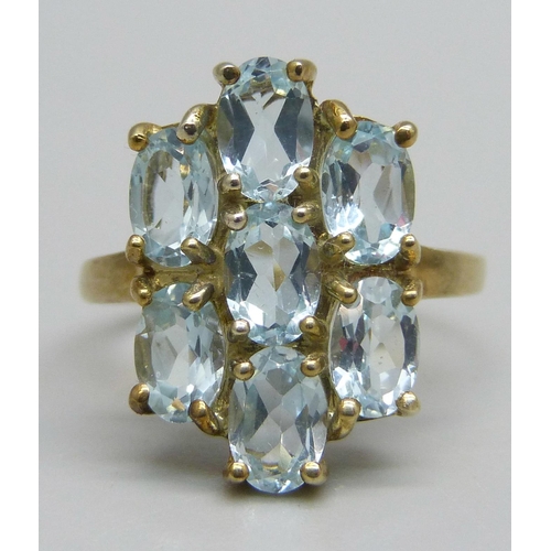 1125 - A silver gilt ring set with seven sky blue topaz stones, O