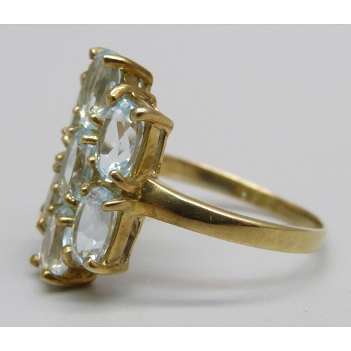 1125 - A silver gilt ring set with seven sky blue topaz stones, O