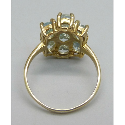 1125 - A silver gilt ring set with seven sky blue topaz stones, O