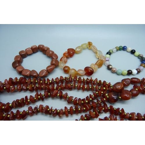 1128 - Hardstone necklets and bracelets including malachite, carnelian, etc.