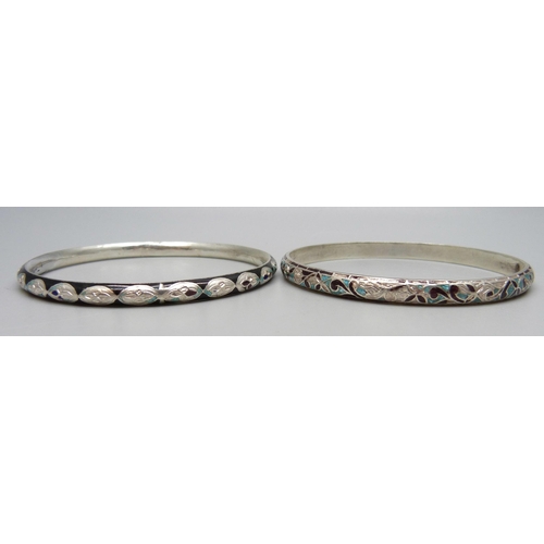 1132 - Two white metal and enamelled bangles, enamel a/f, tests as silver, 27g