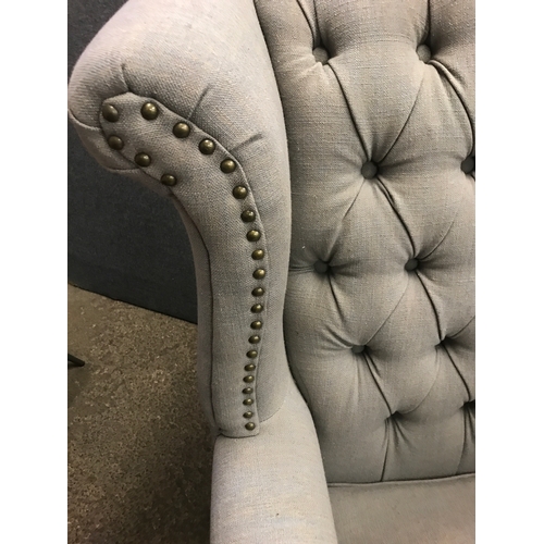 1474 - A grey upholstered buttoned wingback armchair