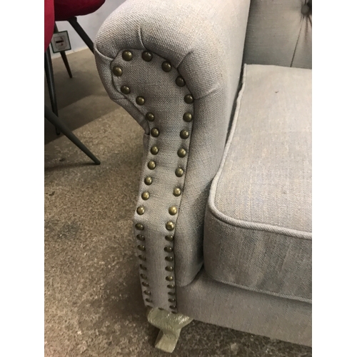 1474 - A grey upholstered buttoned wingback armchair