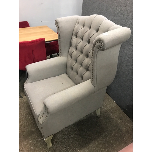 1474 - A grey upholstered buttoned wingback armchair