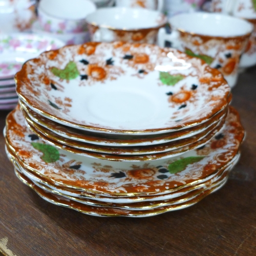 670 - A Grafton tea set decorated with pink flowers, a Spode tea set and a Wellington china part tea set *... 