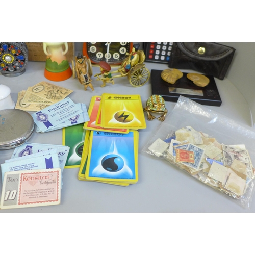 672 - A collection of assorted items including stamps, Pokemon cards, a clock, etc.