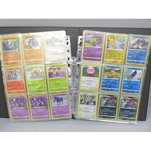 690 - A folder of approximately 300+ holographic Pokemon cards