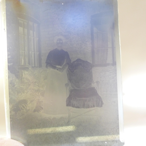 694 - An album of Edwardian and later postcards and a box of Edwardian glass negatives, mainly family grou... 