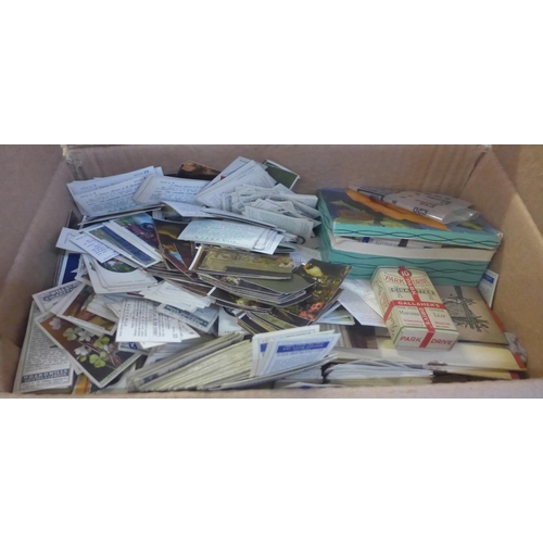 721 - A box of cigarette cards and albums