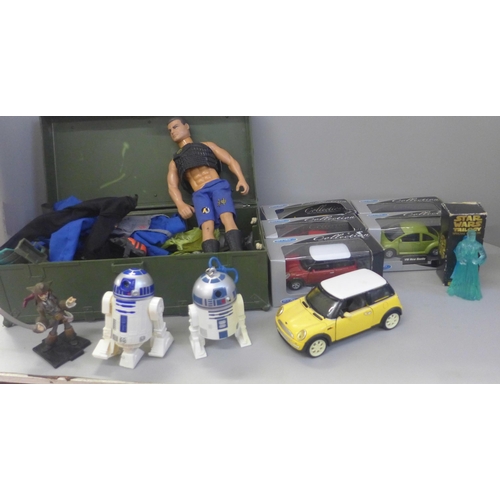 746 - An Action Man figure with a collection of clothes and accessories and a collection of model cars (so... 