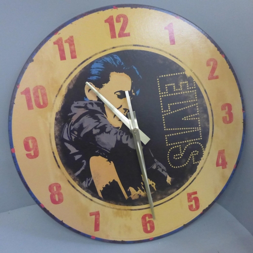 749 - Elvis Presley memorabilia, two scarves, a scrap album, DVDs, a figure, a clock, a belt buckle, etc.