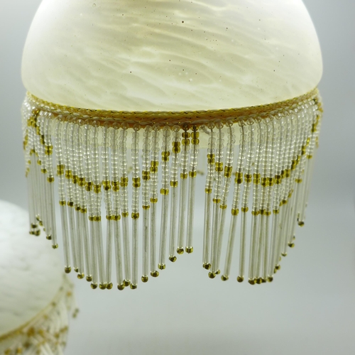 778 - A pair of Art Deco style glass light shades, compacts, a cameo, etc.