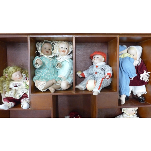 803 - A doll display case with thirteen small china dolls and one other larger doll **PLEASE NOTE THIS LOT... 