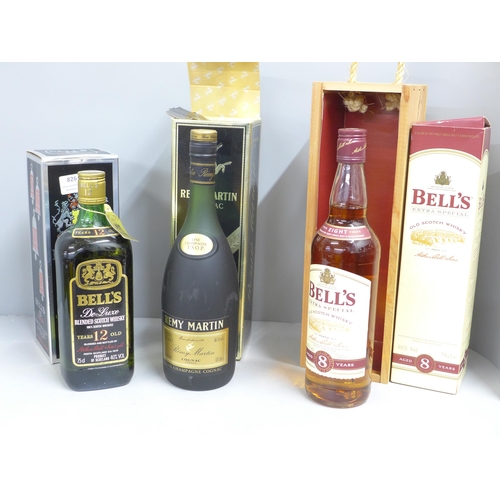 826 - A bottle of Remy Martin Cognac Fine Champagne VSOP, boxed and two boxed bottles of Bell's Whisky, 12... 