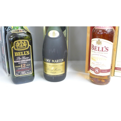 826 - A bottle of Remy Martin Cognac Fine Champagne VSOP, boxed and two boxed bottles of Bell's Whisky, 12... 