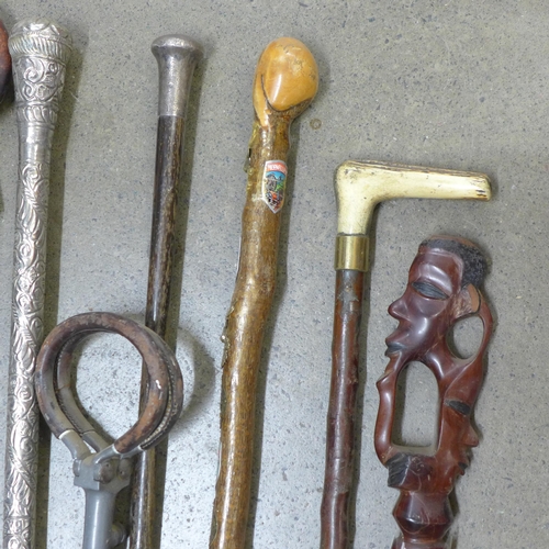 840 - A collection of seven walking sticks including one with silver top and a shooting stick **PLEASE NOT... 