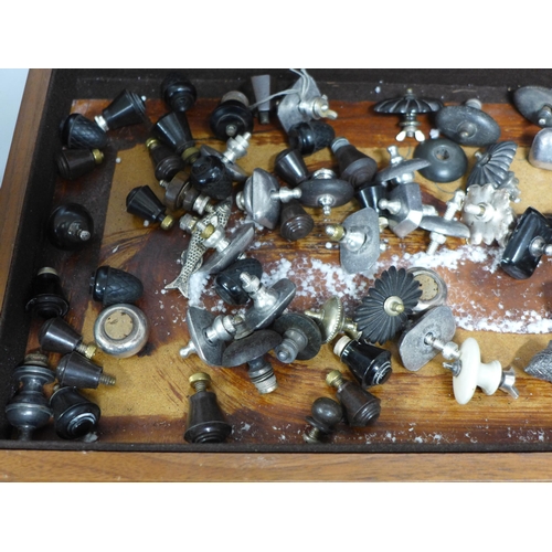 841 - A large wooden box containing over 110 various knobs and screws to fit teapots, coffee pots, dishes,... 