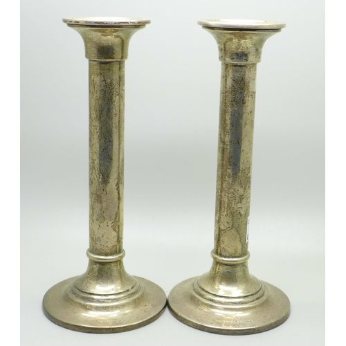 878 - A pair of silver candlesticks, marked Barton Silver,  weighted, 18cm