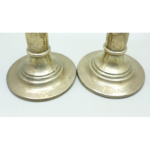 878 - A pair of silver candlesticks, marked Barton Silver,  weighted, 18cm