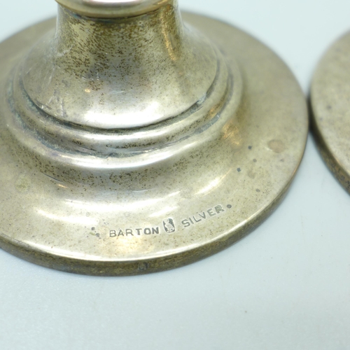 878 - A pair of silver candlesticks, marked Barton Silver,  weighted, 18cm