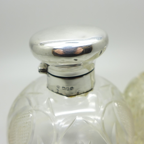 884 - Two silver topped glass scent bottles, one by William Comyns