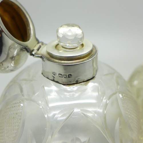 884 - Two silver topped glass scent bottles, one by William Comyns